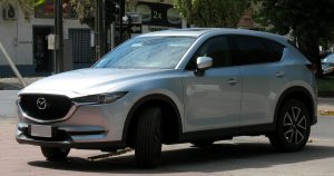 The 2019 Mazda CX-5 in silver parked on the street in Wichita, KS