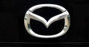 The Mazda crest on a vehicle's front grille, located in Wichita, KS