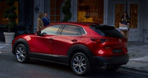 A red 2020 Mazda CX-30 parked outside a shop in Wichita, KS