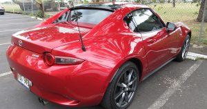 A red 2019 Mazda MX-5 Miata parked outside of a field in Wichita, KS